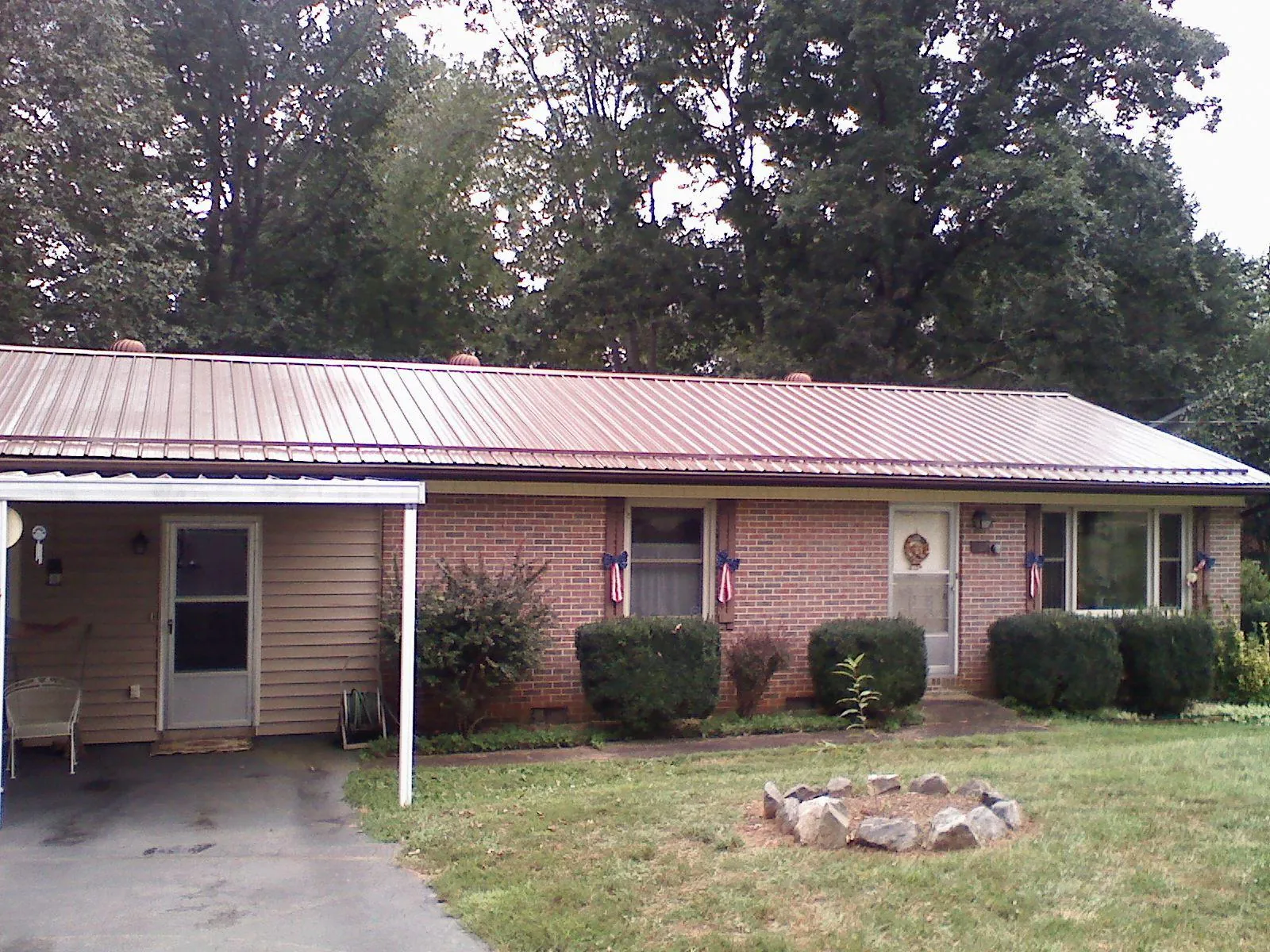 Bronze metal roof and carport on a brick ranch home — Roof Repair work by our crew in White Haven