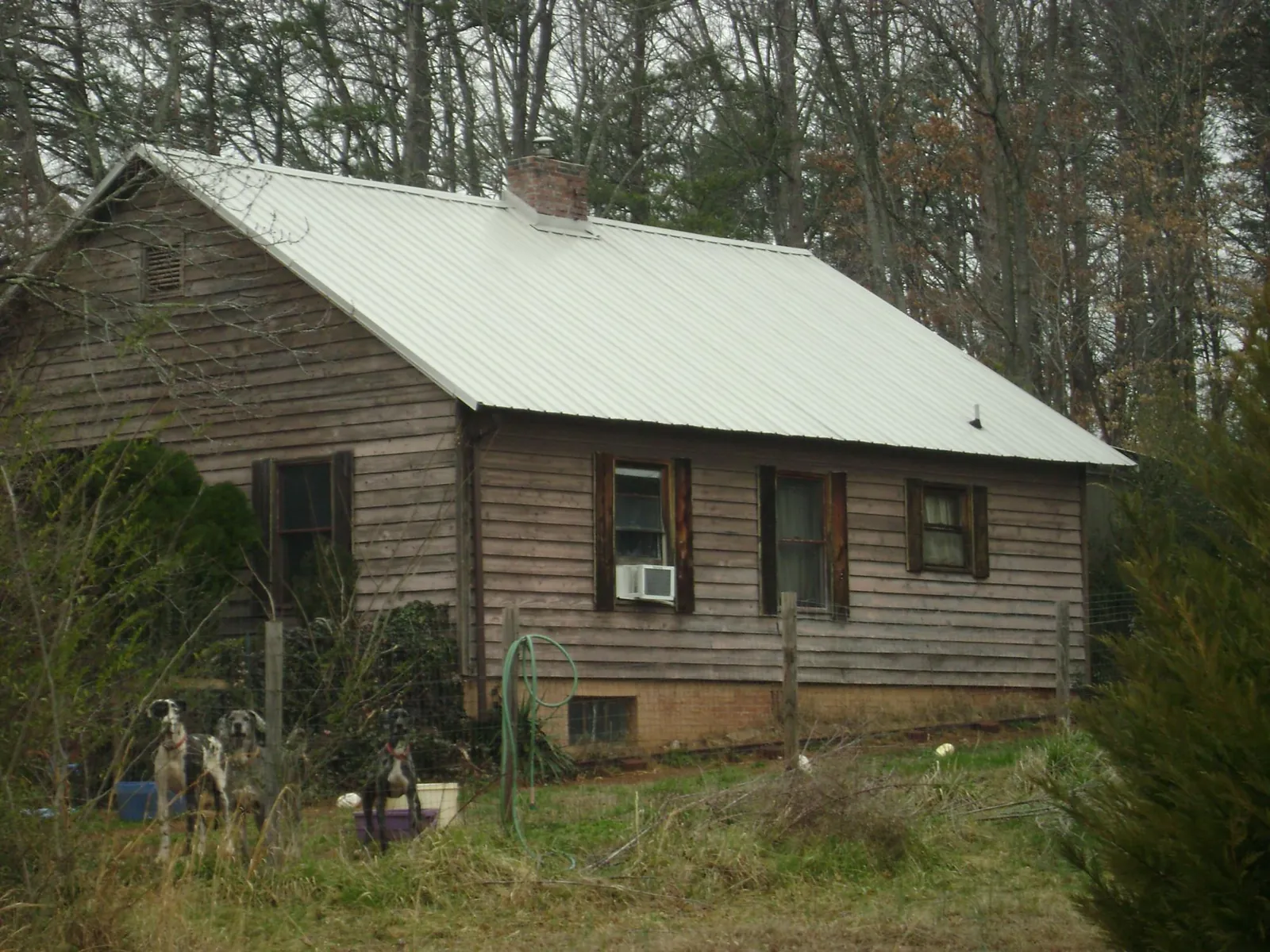 White metal roof on an old wood sided farmhouse, from a Asphalt Shingle Roof Repair job in White Haven